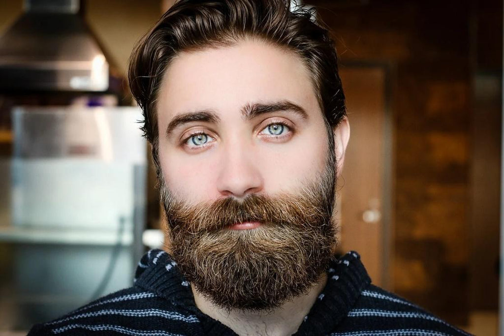 A man with a beard and green eyes